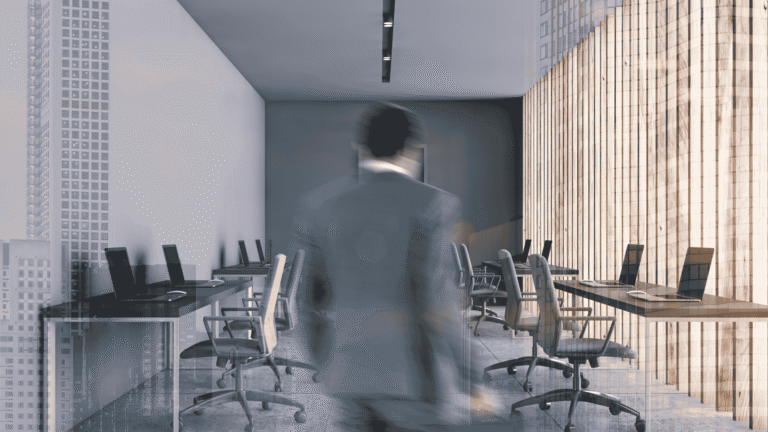 Blurry person walking through a modern glass-walled conference room with laptops on tables and city views outside